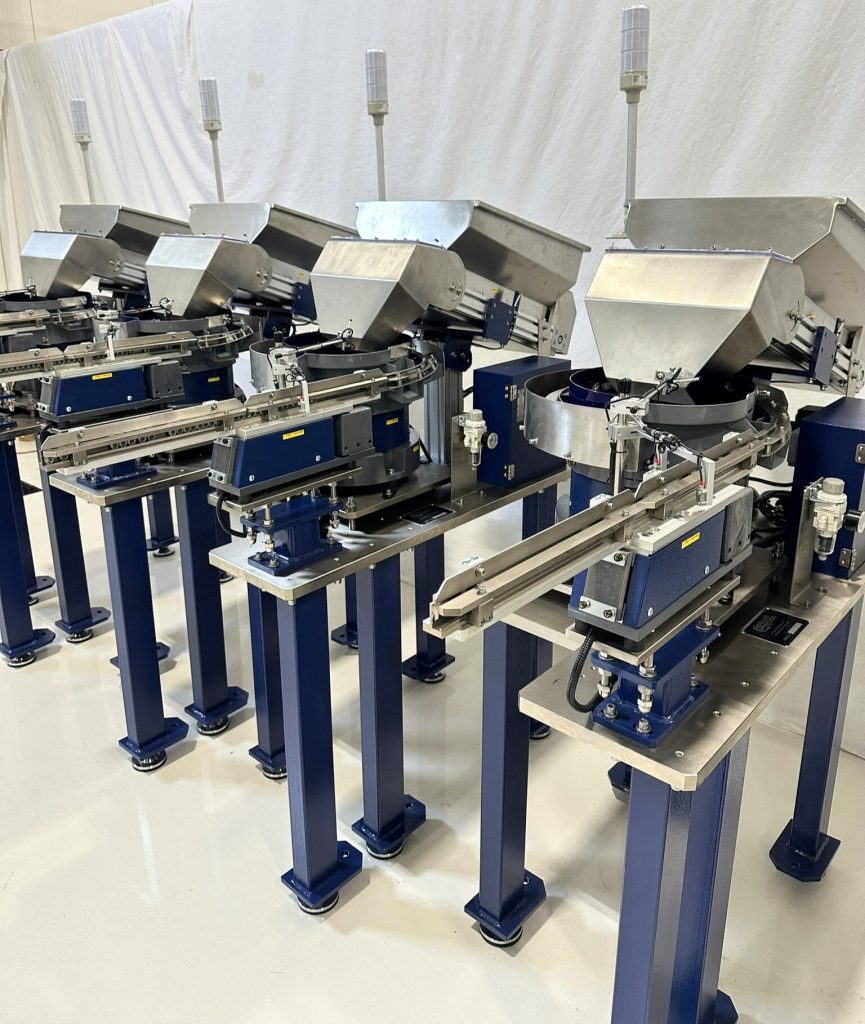 photo of 4 of the vibratory bowl feeder systems completed and set-up