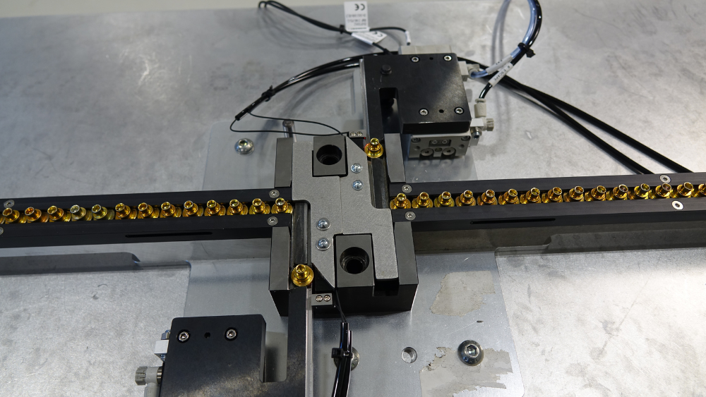 Custom escapement delivering rivets to exact location on the existing press.