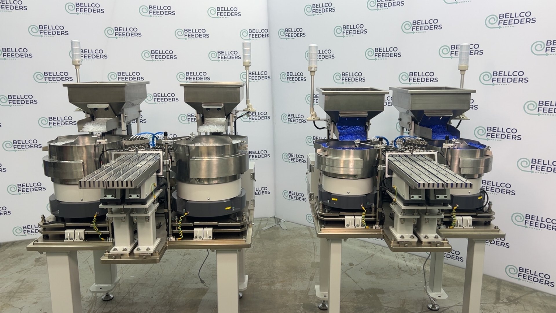 Four Bellco vibratory bowl feeders built as one system, photographed together before shipment