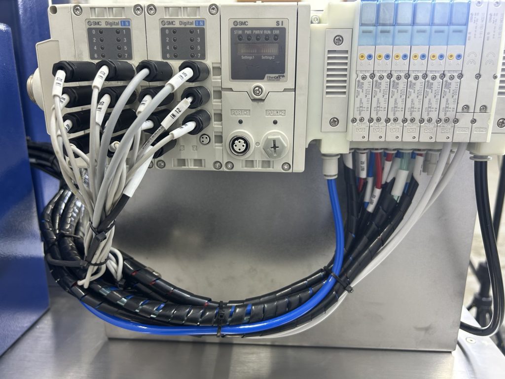 SMC pneumatic valve manifold and wiring inside a Bellco control enclosure