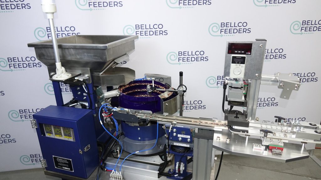 Complete Bellco system feeding copper ring terminals: a 500mm vibratory bowl, linear track and custom dual-belt conveyor on one base