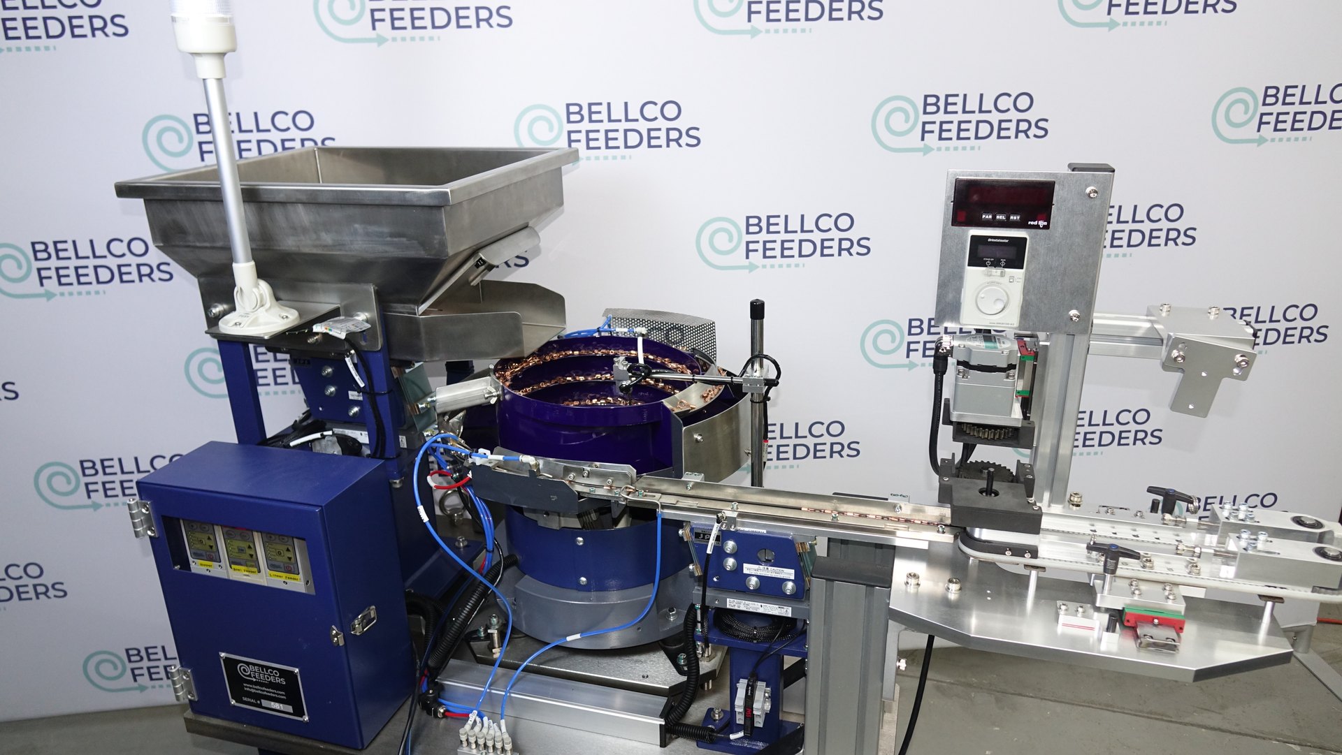 Complete Bellco system feeding copper ring terminals: a 500mm vibratory bowl, linear track and custom dual-belt conveyor on one base