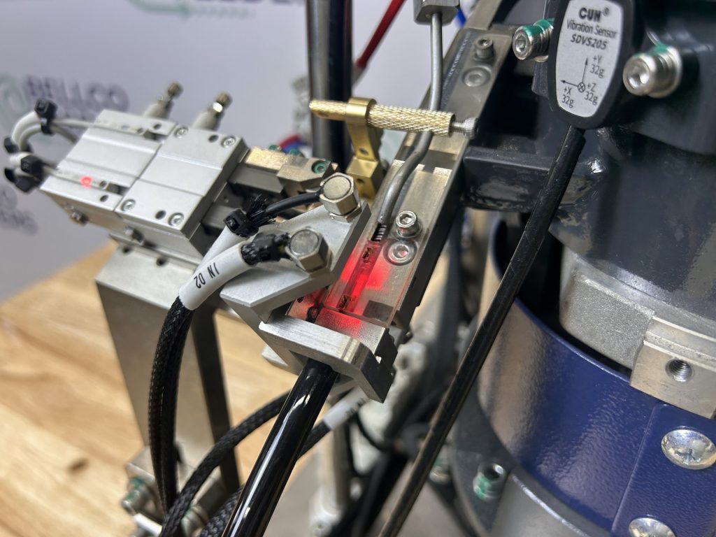 Close view of the gate and air fitting on a Bellco blow-feed escapement