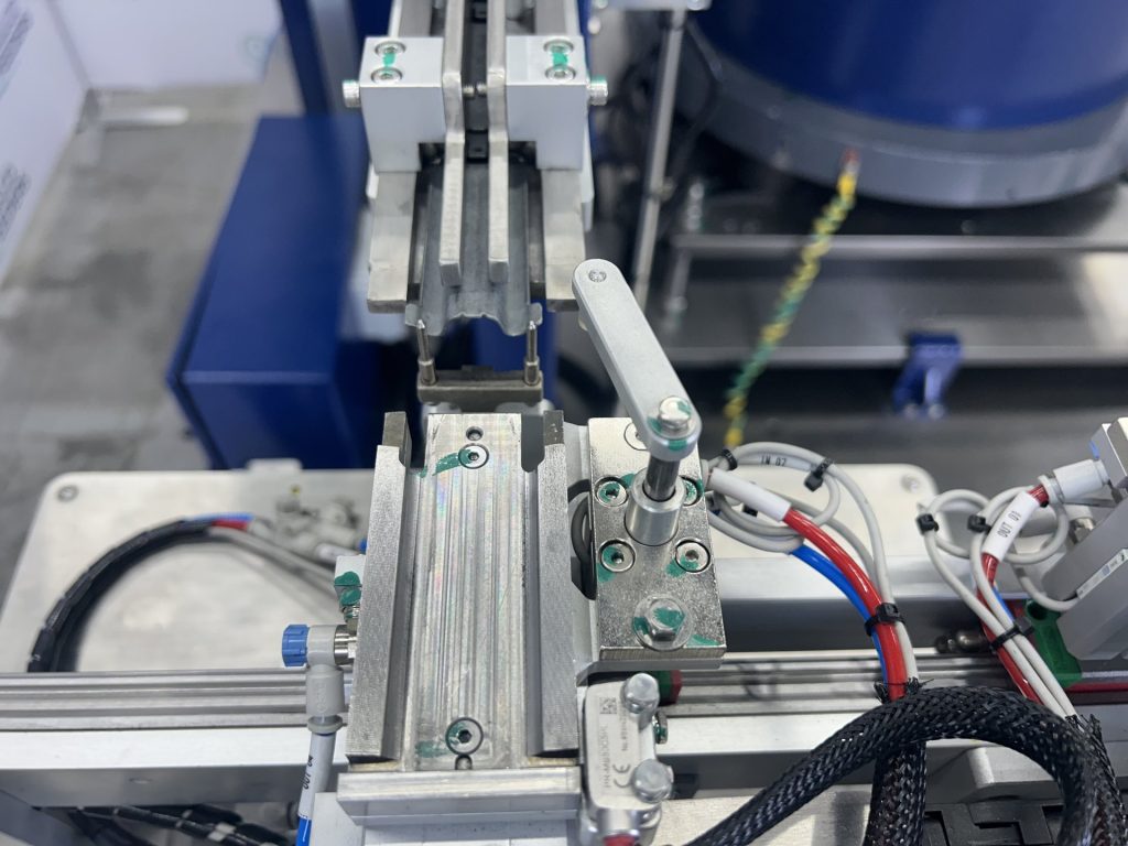 Close view of the cylinders and flow controls on a Bellco multi-stage pneumatic escapement
