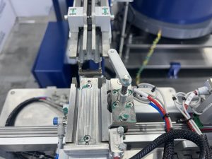 Close view of the cylinders and flow controls on a Bellco multi-stage pneumatic escapement