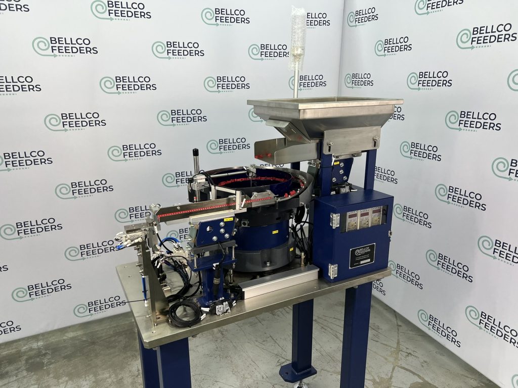 Bellco pull-back escapement on a stand-alone bowl feeder, photographed against the Bellco backdrop