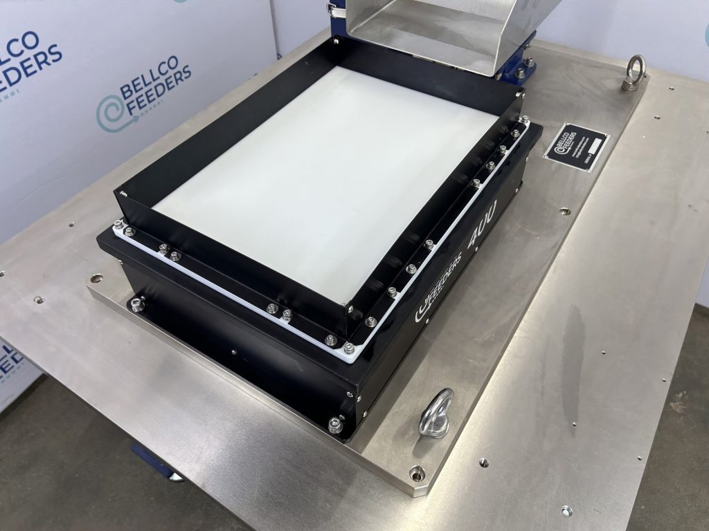Overhead view of the backlit platform on a Bellco Flex feeder, which spreads parts out for a vision-guided robot