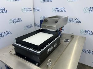 Bellco Flex feeder photographed from the hopper side, showing the bulk refill chute above the platform