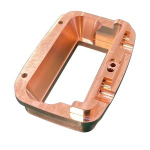 Copper machined housing with a precision bore and mounting features