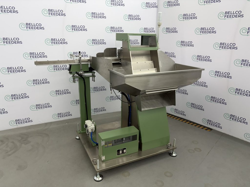 Side view of a Bellco step feeder showing the step elevating mechanism, green powder-coated frame and adjustable leveling feet