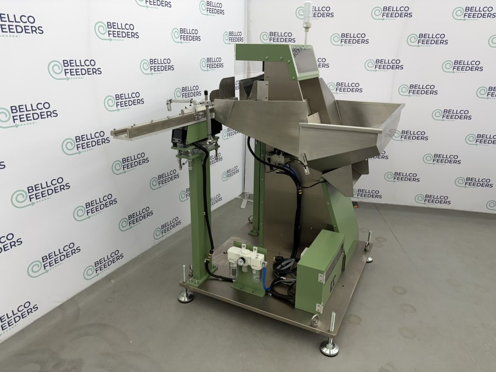 Bellco step feeder photographed from the outfeed side, with the linear track set to a forty-inch discharge height