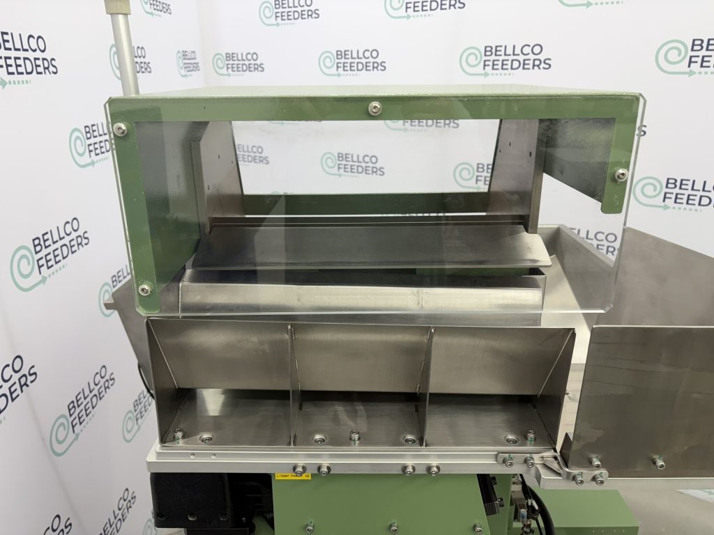 Enclosed actuator guarding on the back of a Bellco step feeder keeps operators clear of the moving step mechanism