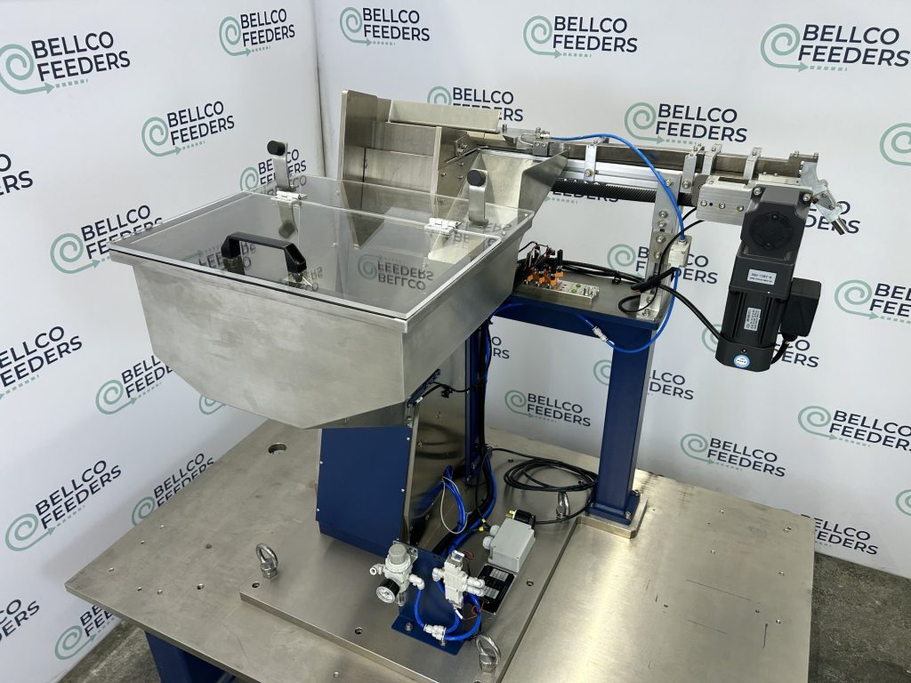 Stand-alone Bellco step feeder on rolling casters, feeding tapered tubes to a 400mm linear track