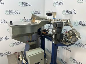 Keyence IV-4 vision camera mounted over the linear track of a Bellco step feeder to check which end of each tube is leading