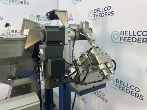 Vision inspection station on a Bellco step feeder, with the camera, lighting and reject gate mounted together