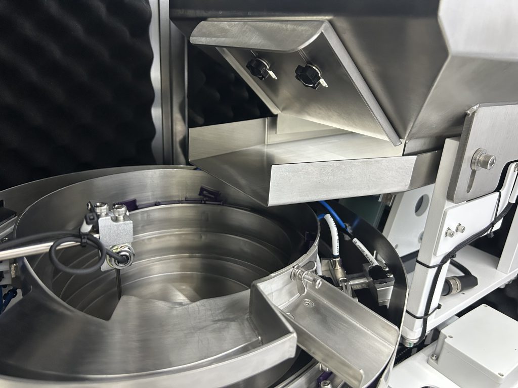 bulk parts hopper feeding int vibratory bowl feeder