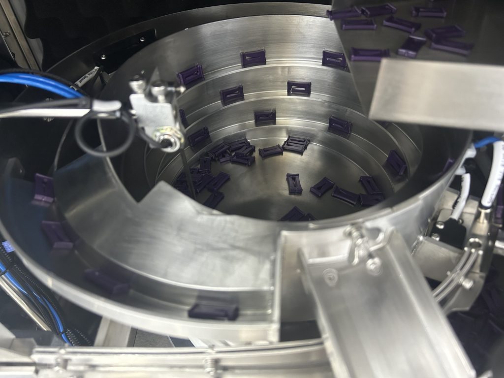 small plastic clips for medical device assembly in a vibratory bowl feeder