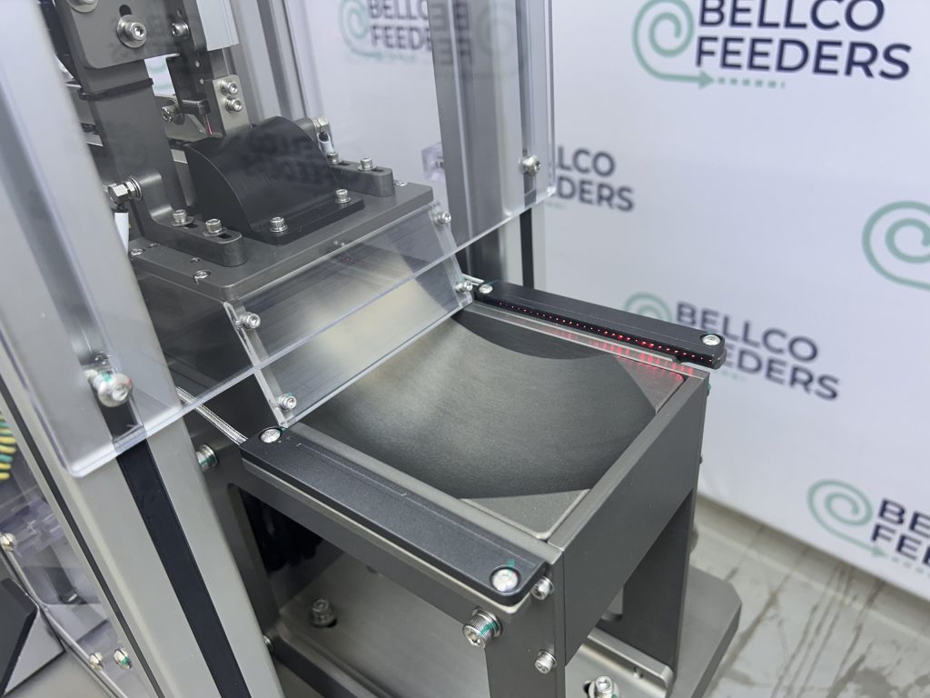 scoop style escapement for operator pick-up