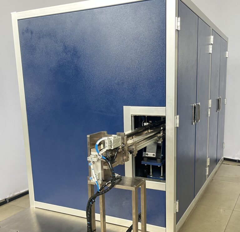 Blue acoustic sound enclosure around a feeder system, with the feed track exiting the front