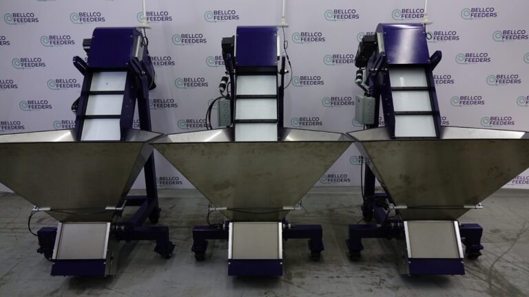 Three stainless steel elevated pre-feeders on casters
