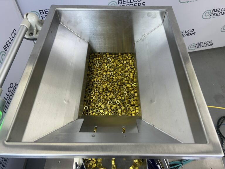 Stainless steel vibratory hopper filled with small brass parts